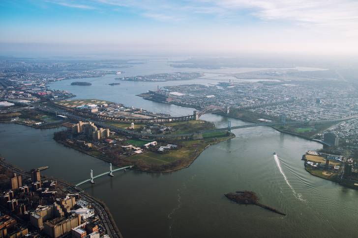 View from a helicopter to Randall's Island and the East River, along with the Robert F. Kennedy Bridge and Hell Gate Bridge.